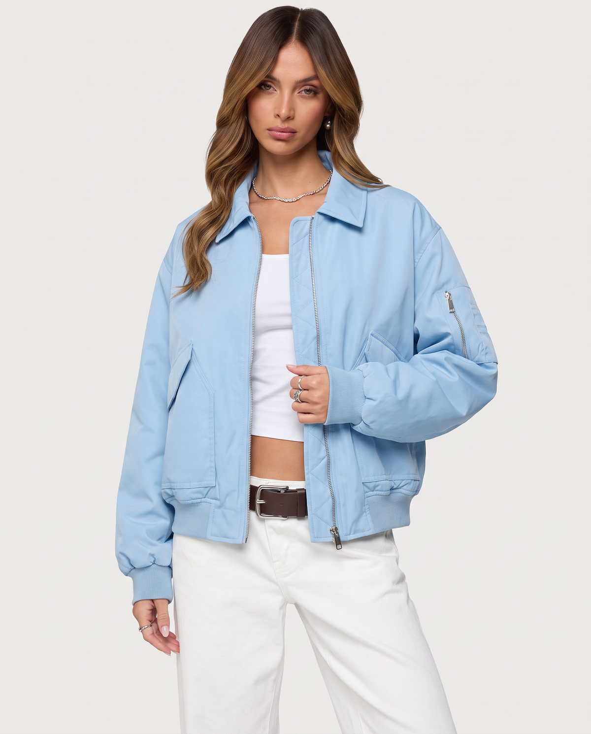Baby blue Capsule Bomber jacket by STYLEBURY displayed on a hanger, featuring a sleek design and ribbed cuffs and collar.