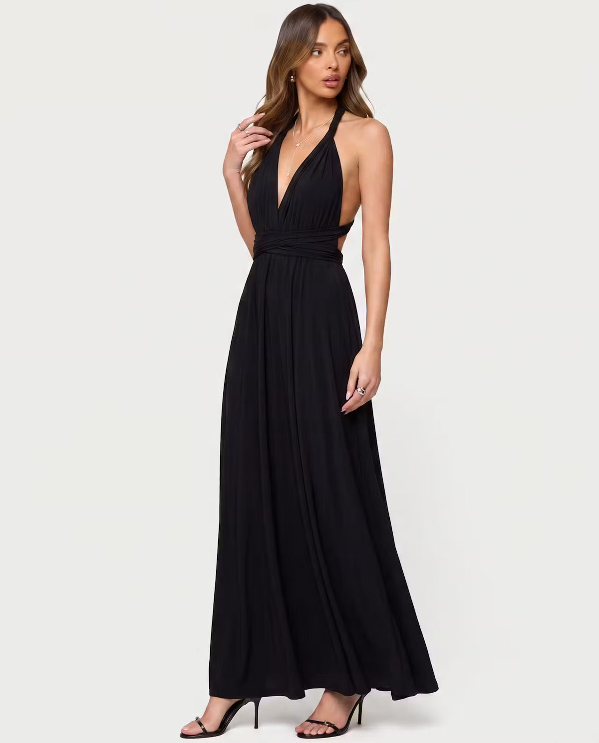 Black twisted maxi dress by STYLEBURY displayed on a hanger with flowing fabric and elegant design details.
