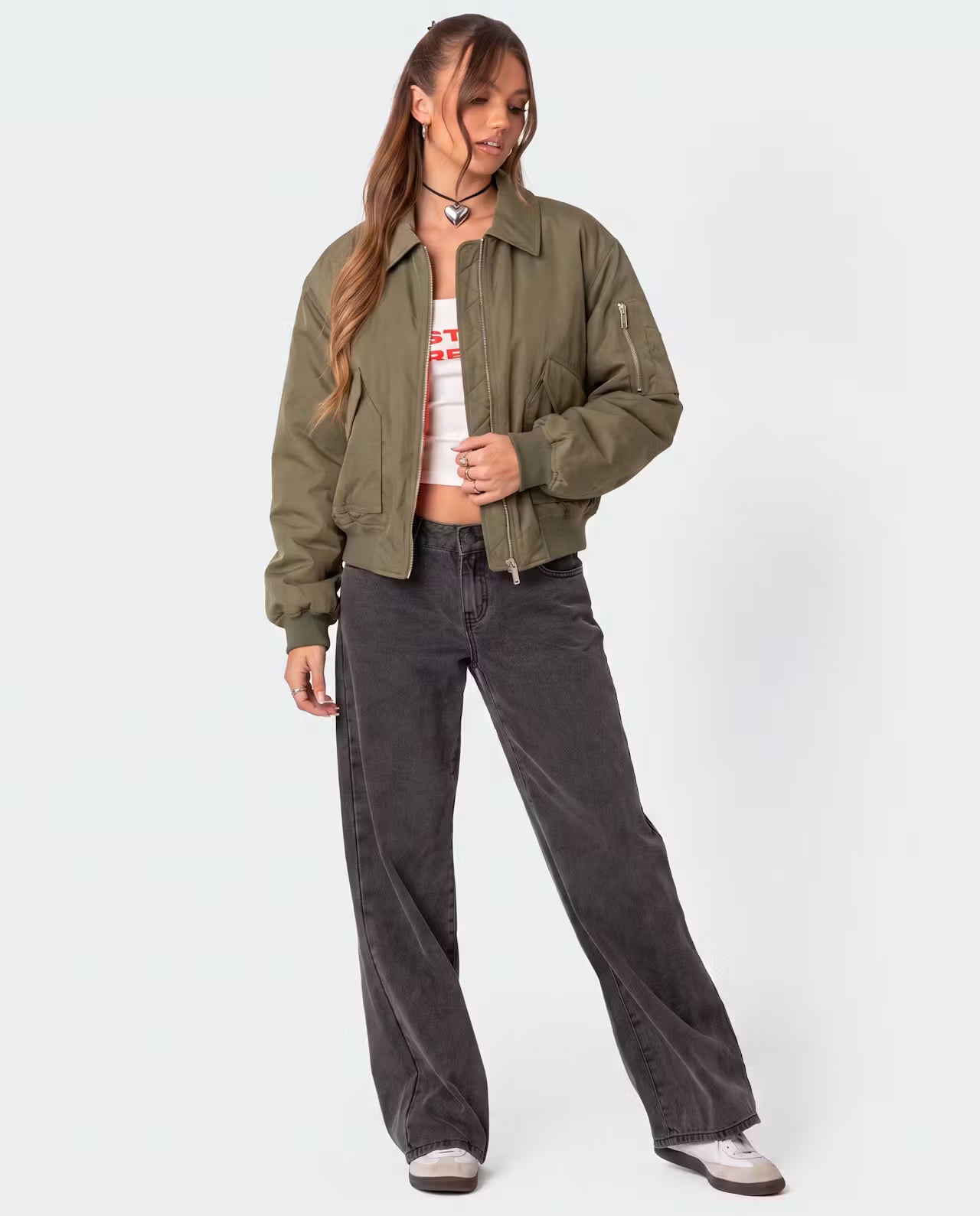 Khaki Capsule Bomber jacket by STYLEBURY with a fitted design, ribbed cuffs, and a front zipper, displayed on a hanger.